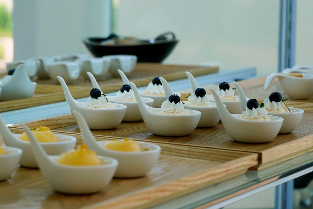 A table topped with lots of small bowls filled with food